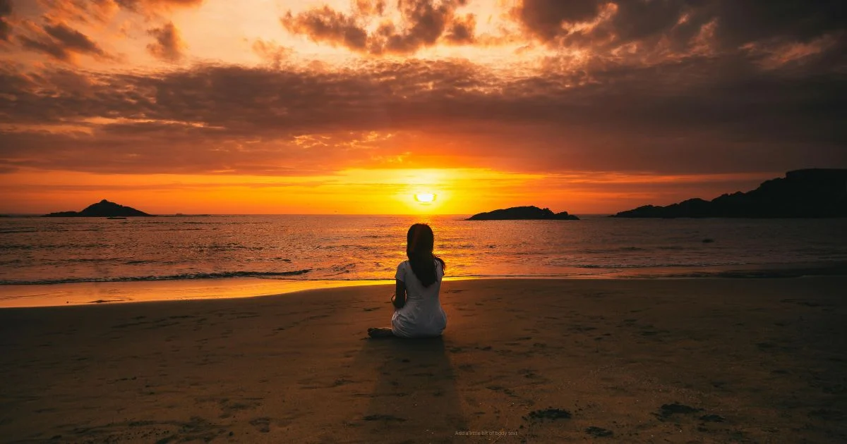 woman sat on sunset beach; niio dance