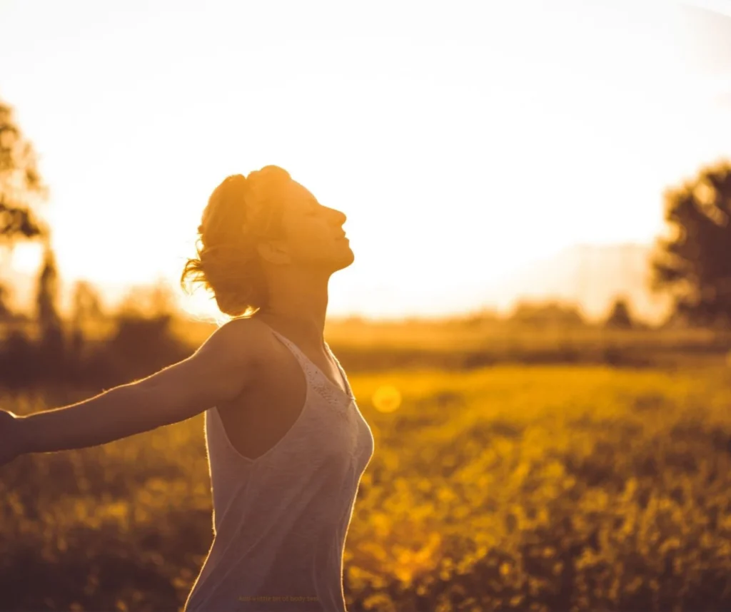 woman standing outside in the sun, visionary somatic dance